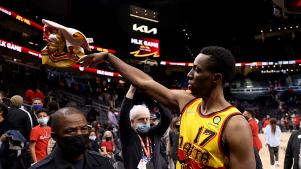 Jan 17, 2022; Atlanta, Georgia, USA; Atlanta Hawks forward Onyeka Okongwu (17) throws a towel into the stands as he celebrates their win against the Milwaukee Bucks at State Farm Arena.